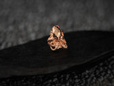 Front profile of rose-gold octopus ring showing plating details.