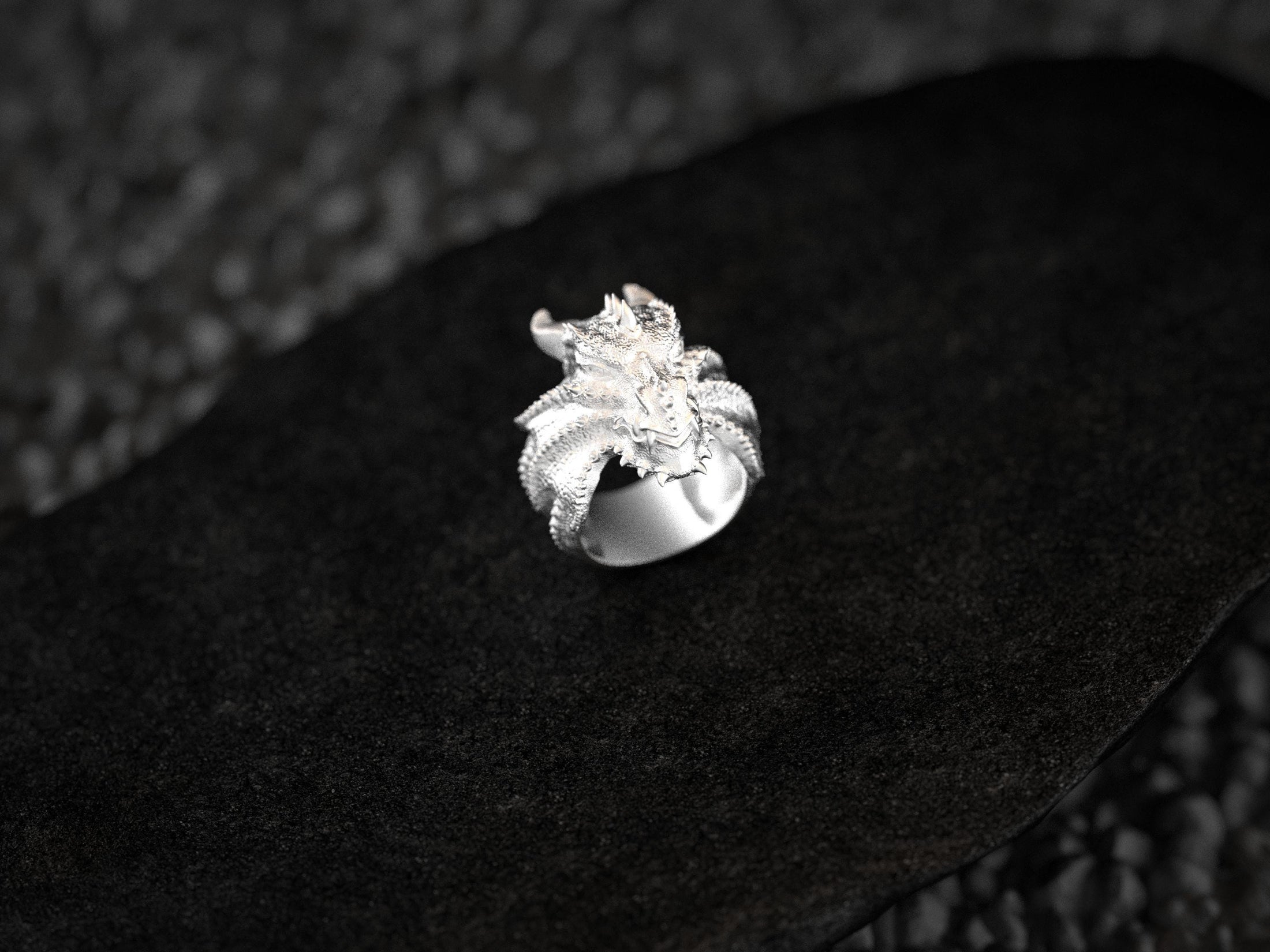 Front view of the polished sterling silver dragon head ring highlighting its fierce expression.