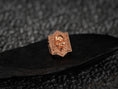 Load image into Gallery viewer, Front view of the warm rose-gold plated variant, showcasing the skull relief and angular geometric border.
