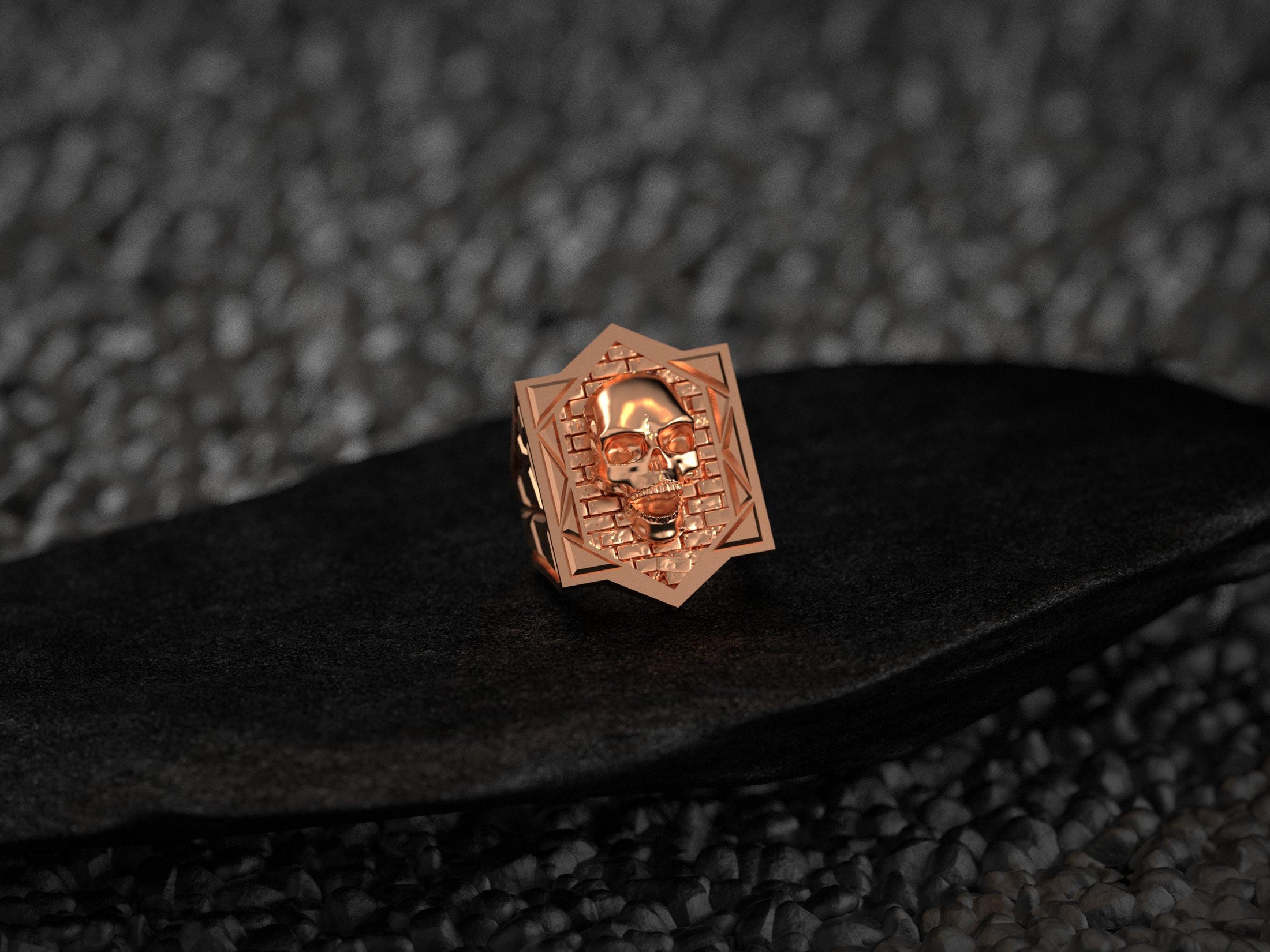 Front view of the warm rose-gold plated variant, showcasing the skull relief and angular geometric border.