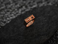 Bild in Galerie-Betrachter laden, Front view of the rose-gold plated variant, showing both skull profiles framed in a slim rectangular bezel.
