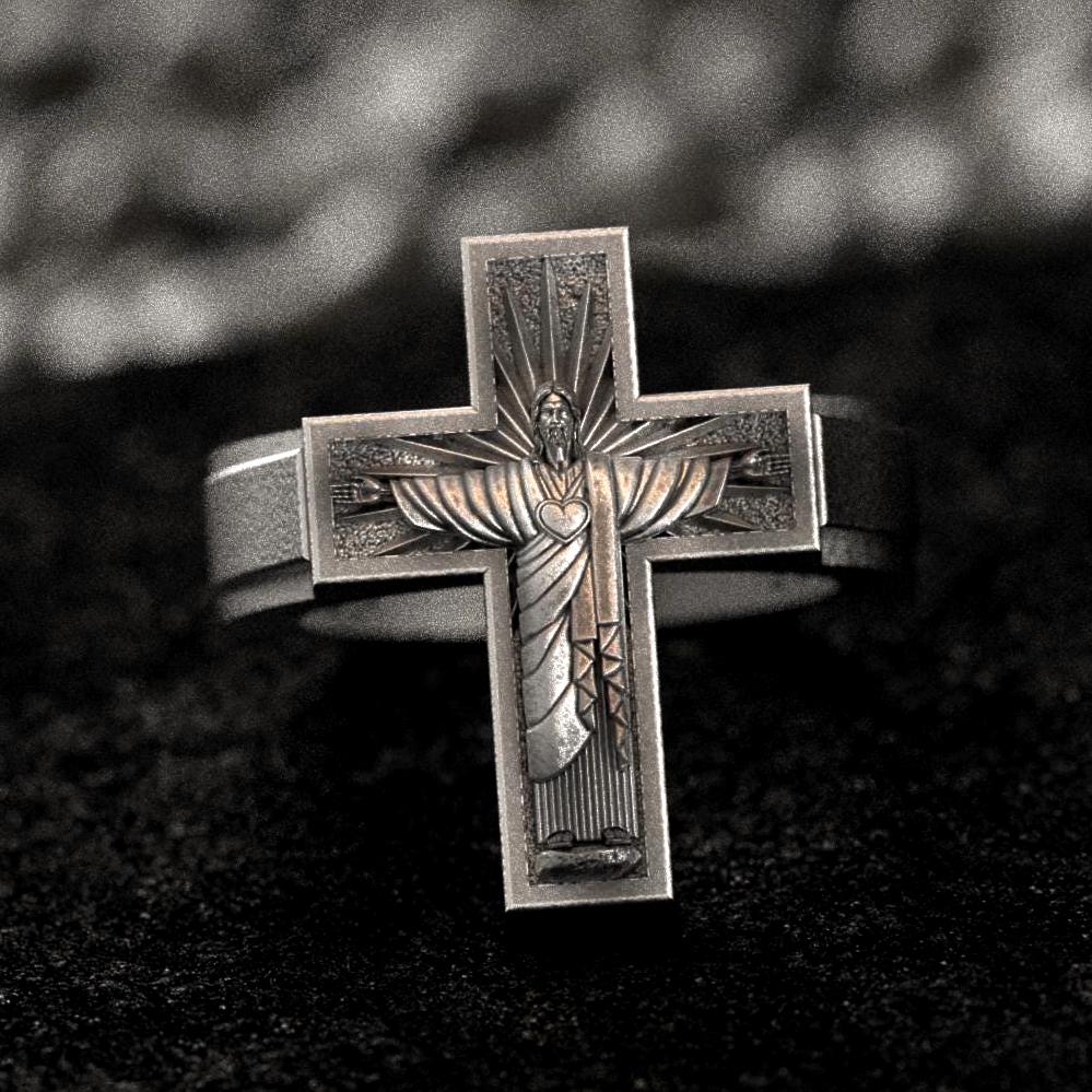 Front-on view of the sterling silver cross signet ring, showcasing the raised Christ figure with a Sacred Heart at its center.