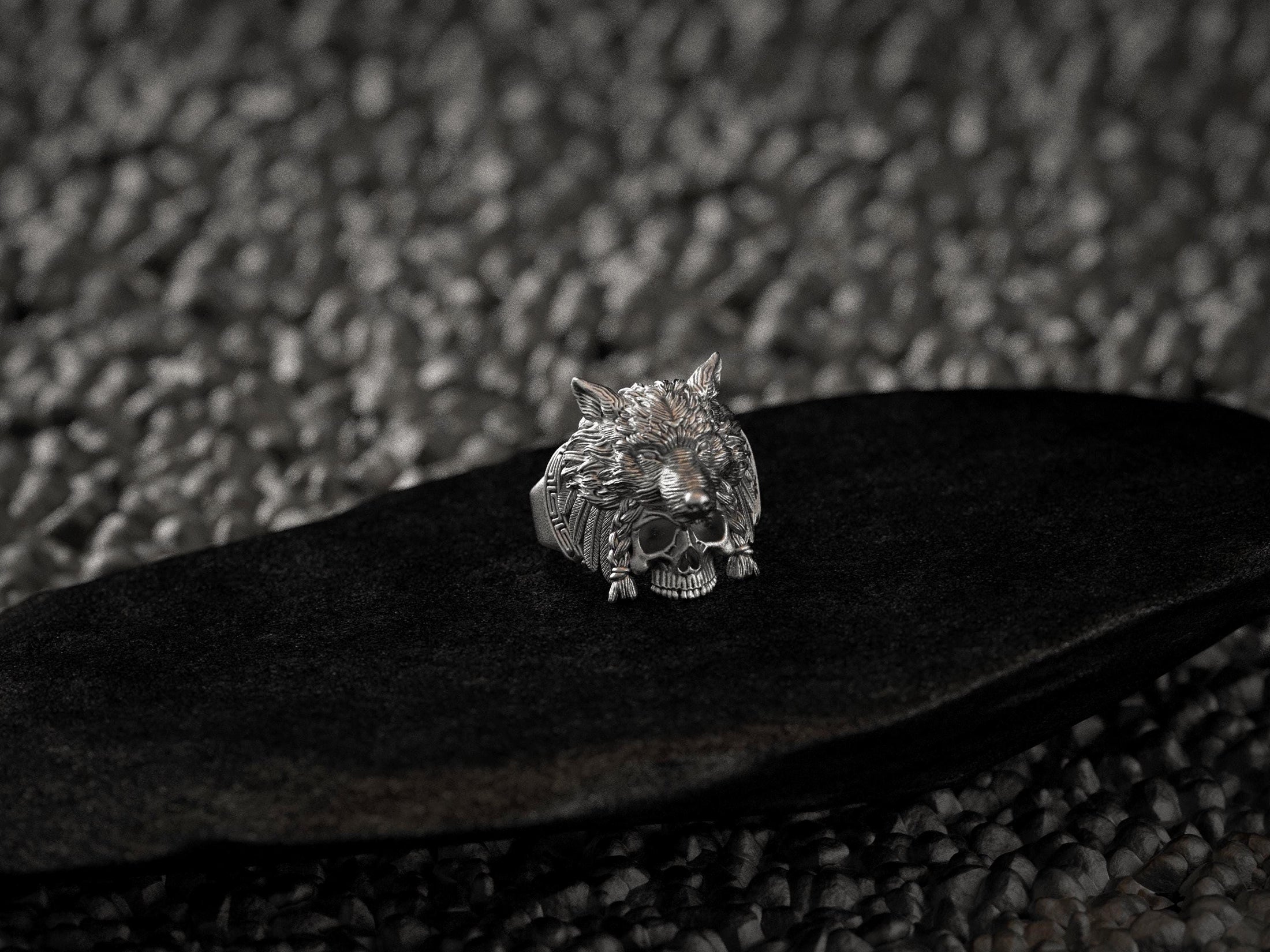 Close-up of detailed wolf fur texture and braided cords on skull ring