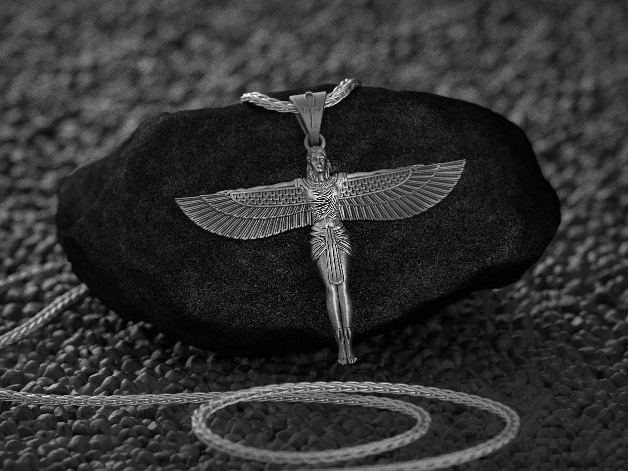 Close-up of Egyptian goddess necklace with intricate wing design.