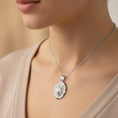 Load image into Gallery viewer, White gold fox pendant with textured oval background.
