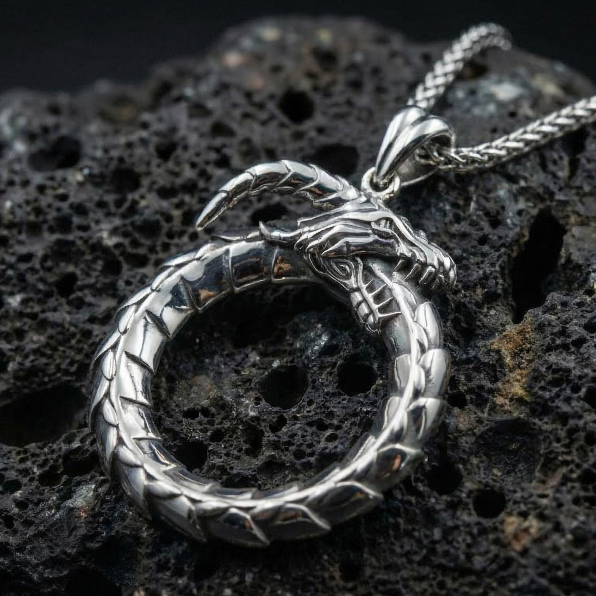 Rhodium plated ouroboros dragon pendant close-up texture