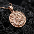 Load image into Gallery viewer, Rose gold plated dragon coin pendant with oriental dragon engraving displayed on volcanic lava stone
