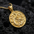 Load image into Gallery viewer, Gold plated dragon medallion necklace round dragon pendant photographed on volcanic rock surface
