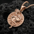 Load image into Gallery viewer, Rose gold plated yin yang dragon medallion necklace with symbolic maze border on volcanic rock surface
