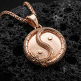 Load image into Gallery viewer, Rose gold plated yin yang dragon medallion necklace with eastern harmony symbol on volcanic rock
