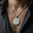 Load image into Gallery viewer, Polished silver dragon and phoenix medallion worn on chest showing balance symbolism jewelry
