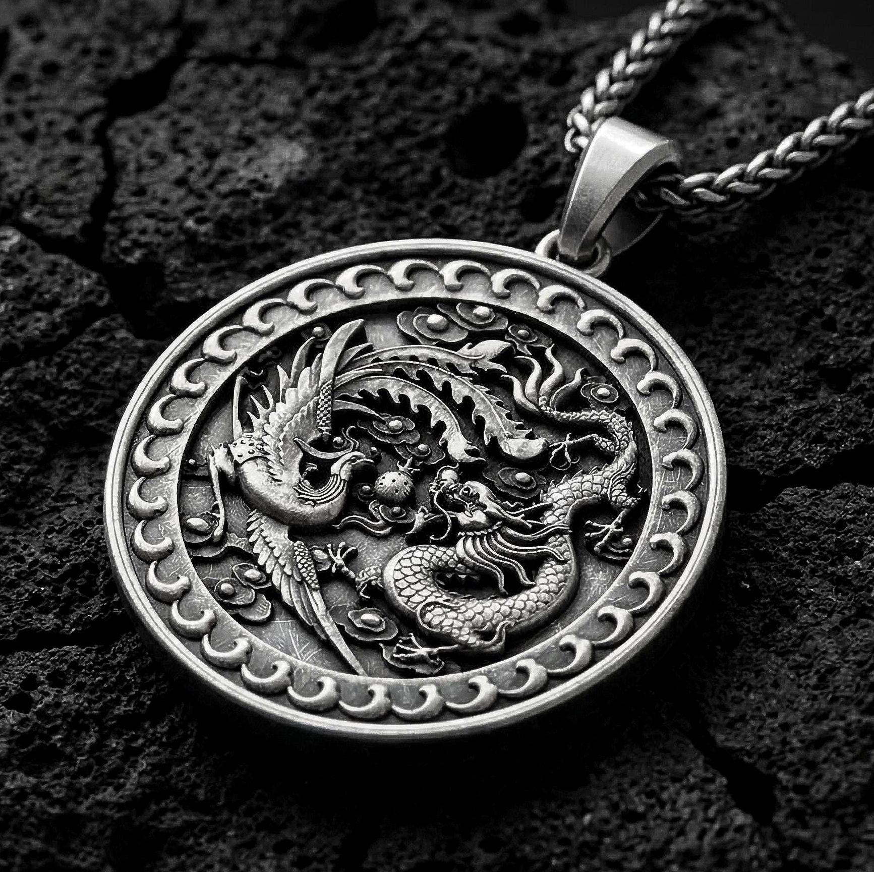 Oxidized dragon and phoenix yin yang pendant necklace on volcanic rock with mythic medallion design