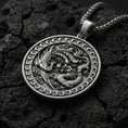 Load image into Gallery viewer, Oxidized dragon and phoenix yin yang pendant necklace on volcanic rock with mythic medallion design
