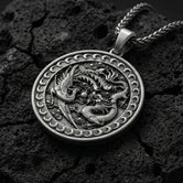 Oxidized dragon and phoenix yin yang pendant necklace on volcanic rock with mythic medallion design