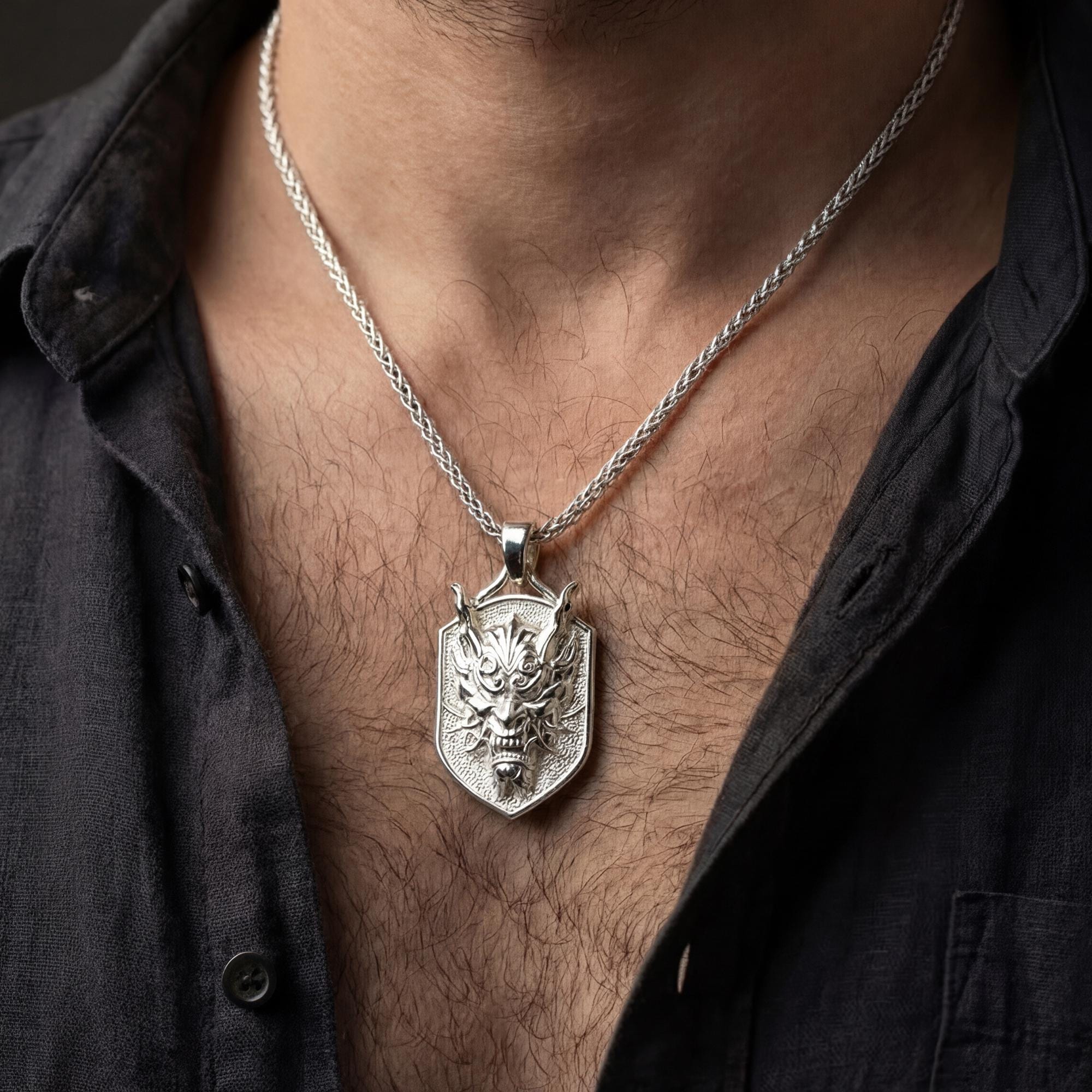 Polished silver oriental demon dragon dog tag necklace worn on chest highlighting warrior myth symbolism