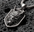 Load image into Gallery viewer, Oxidized oriental demon dragon dog tag pendant necklace photographed on volcanic rock with deep engraved oni mask detail
