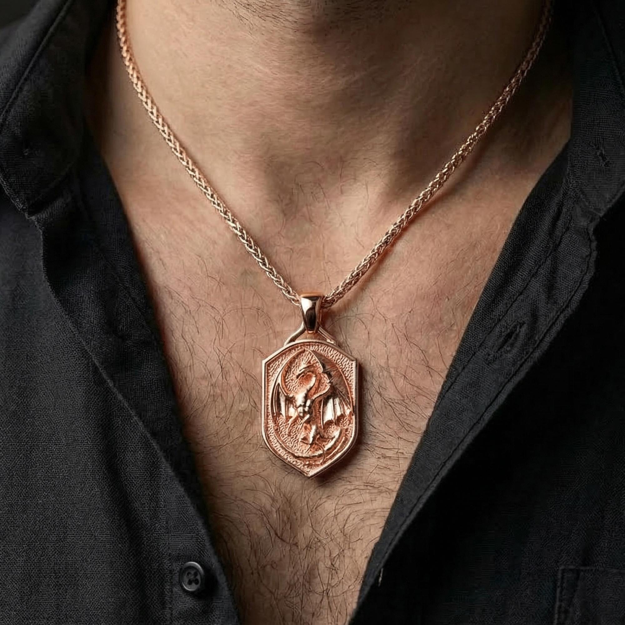 Rose gold plated dragon shield necklace worn on model with powerful fantasy style