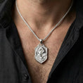Load image into Gallery viewer, Polished silver fantasy dragon shield necklace worn on chest highlighting medieval myth symbolism
