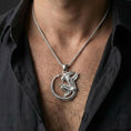 Load image into Gallery viewer, Polished silver xenomorph alien necklace worn on chest highlighting biomechanical sci-fi symbolism
