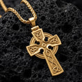 Load image into Gallery viewer, Gold plated celtic cross pendant shown on volcanic rock as spiritual protection jewelry
