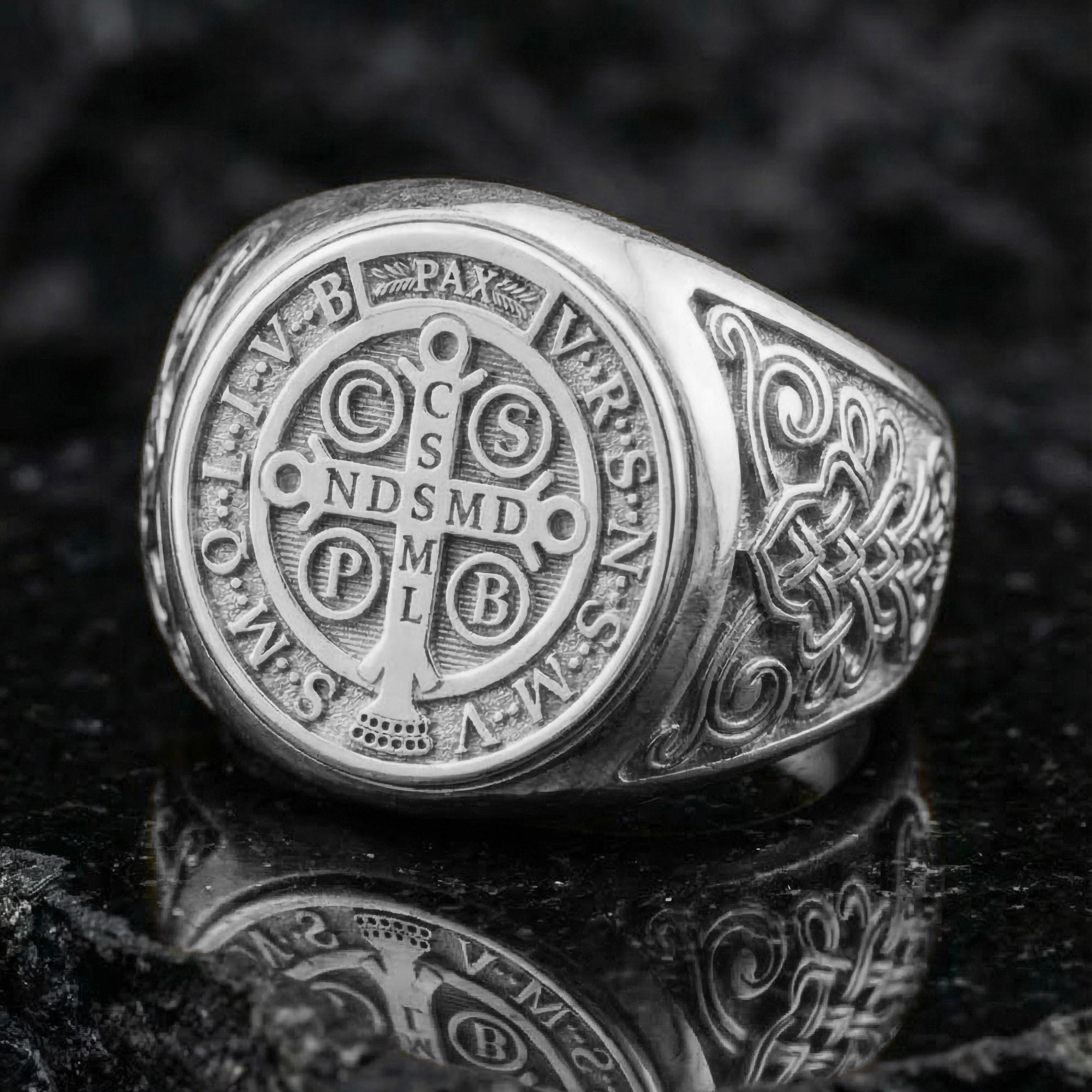 Polished silver St Benedict medal ring on porous volcanic stone, Latin inscription cross design, religious protection jewelry
