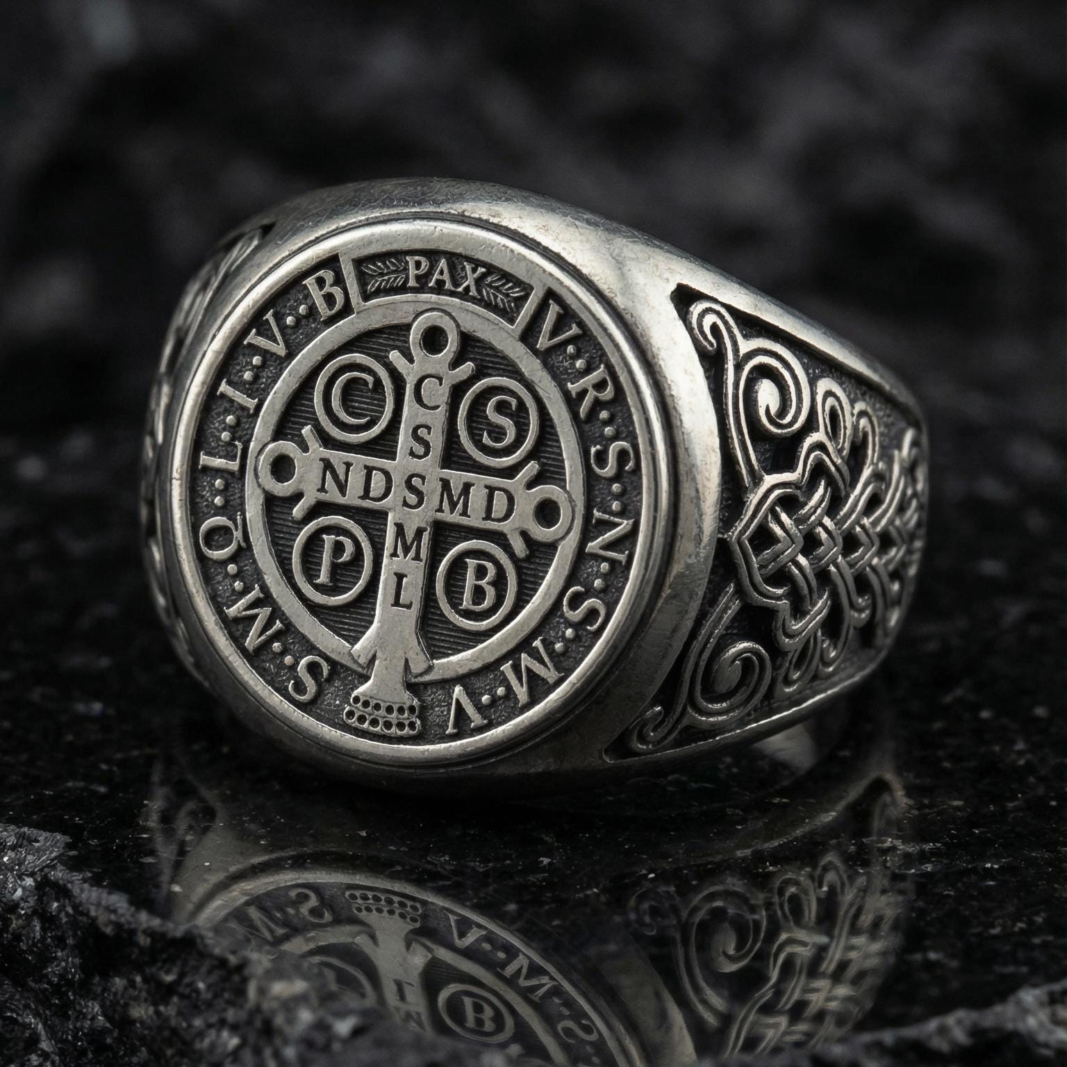 Oxidized sterling silver St Benedict ring on volcanic rock, Benedict medal seal face, Catholic protection symbol signet ring