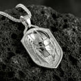 Load image into Gallery viewer, Polished silver protective eye ring on volcanic stone, crisp macro shot emphasizing smooth reflective edges, clean hand contours, and defined iris detail.
