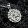 Load image into Gallery viewer, Polished silver dragon coin necklace featuring detailed mythical dragon relief on black volcanic stone

