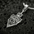 Load image into Gallery viewer, Oxidized dragon shield pendant necklace on volcanic rock with medieval crest design
