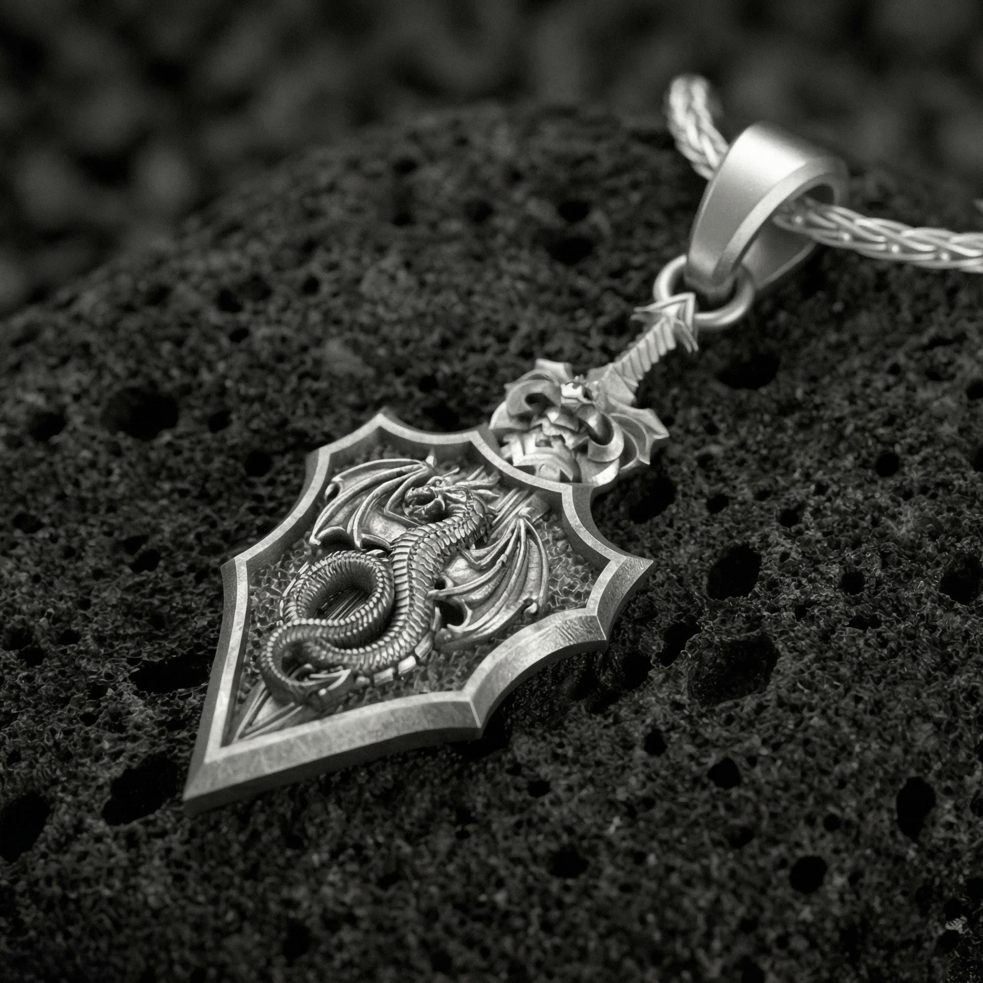 Oxidized dragon shield pendant necklace on volcanic rock with medieval crest design
