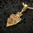Load image into Gallery viewer, Gold plated dragon shield pendant necklace with gothic fantasy armor style on volcanic rock
