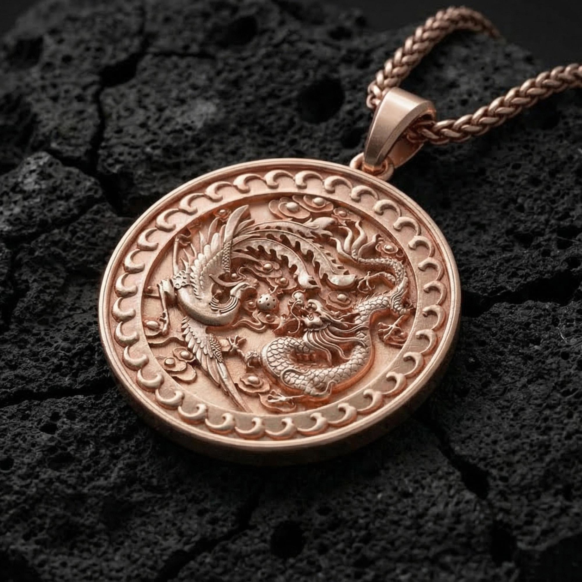 Rose gold plated yin yang dragon phoenix pendant displayed on volcanic rock surface