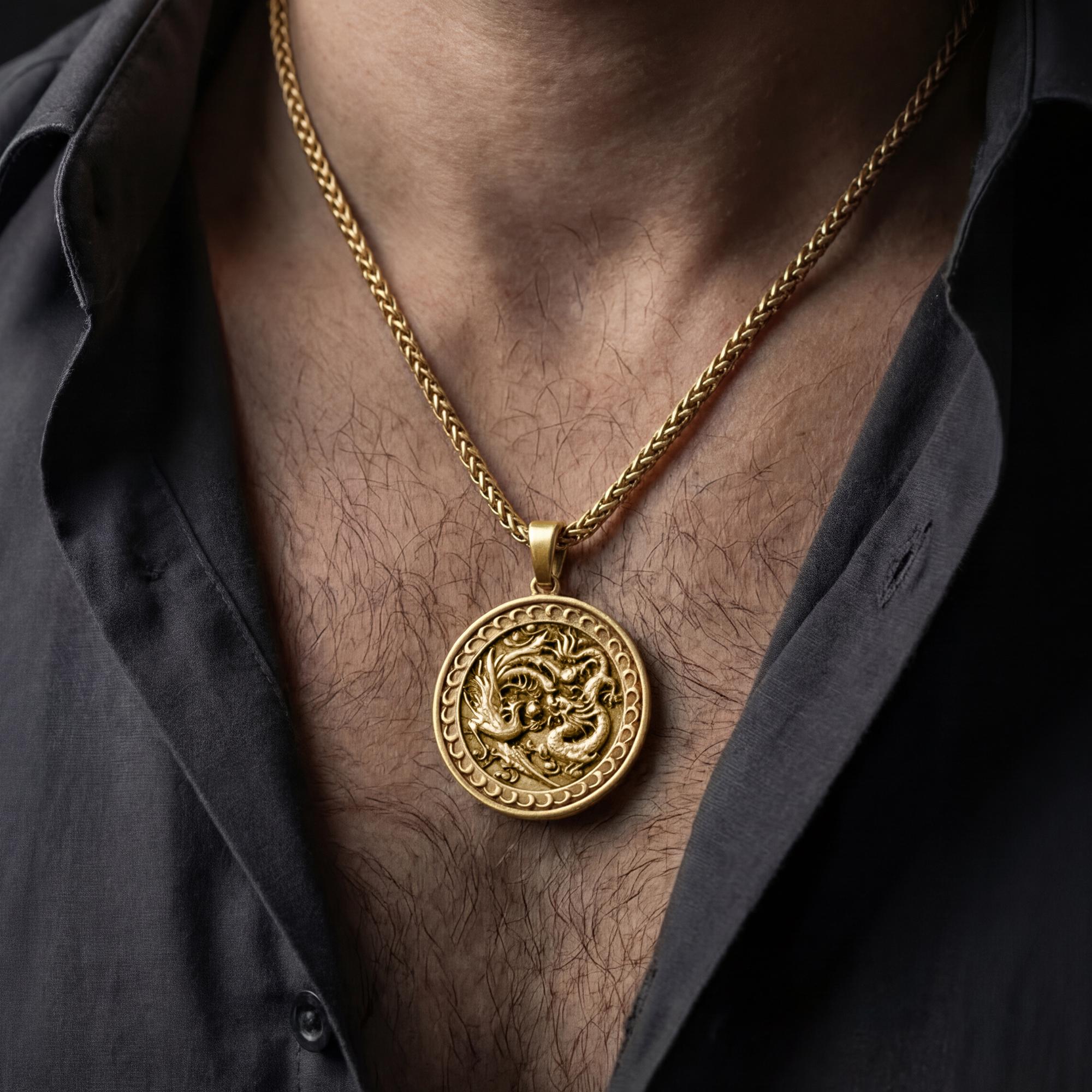 Gold plated yin yang dragon phoenix necklace worn by man as mythological statement pendant