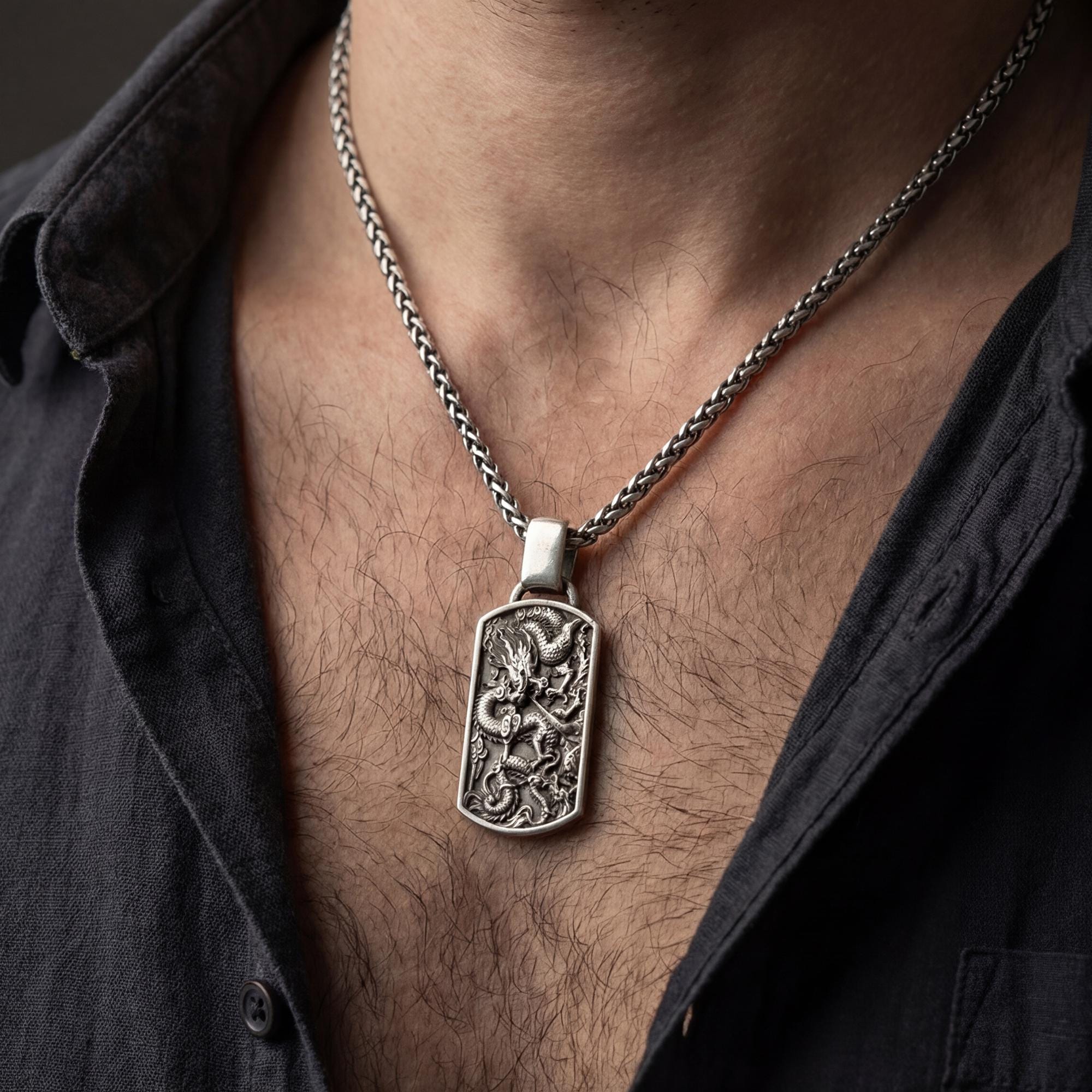 Oxidized chinese dragon dog tag pendant necklace worn on male model as guardian talisman