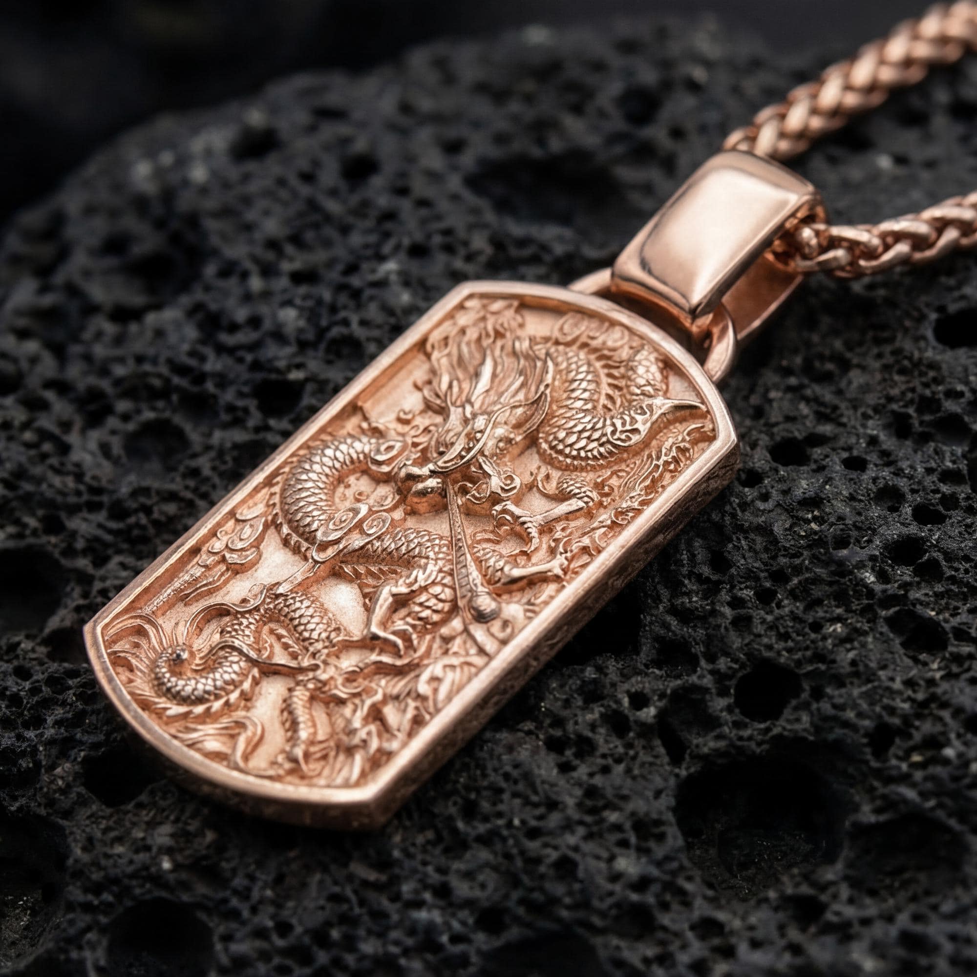 Rose gold plated chinese dragon dog tag necklace showcased on volcanic rock surface