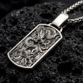 Load image into Gallery viewer, Oxidized chinese dragon dog tag pendant necklace photographed on volcanic rock with deep engraved detail
