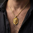 Load image into Gallery viewer, Gold plated oni mask dragon pendant necklace worn by man as bold statement jewelry
