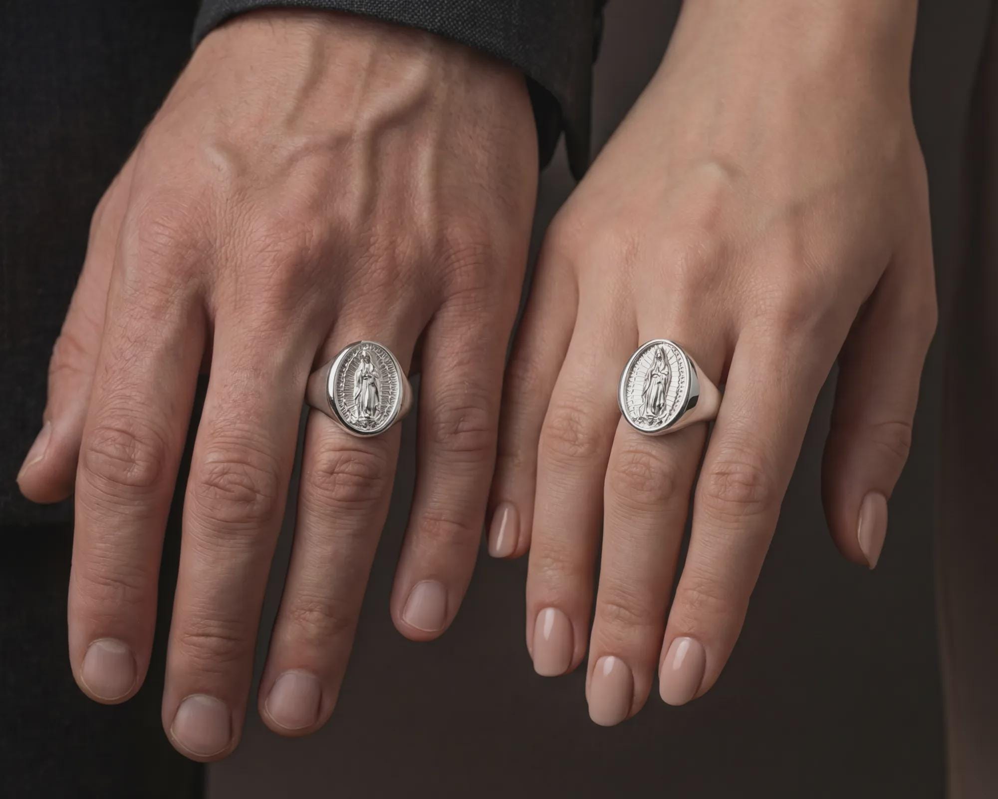 Polished silver Marian signet ring worn on hand showing devotional Catholic symbolism