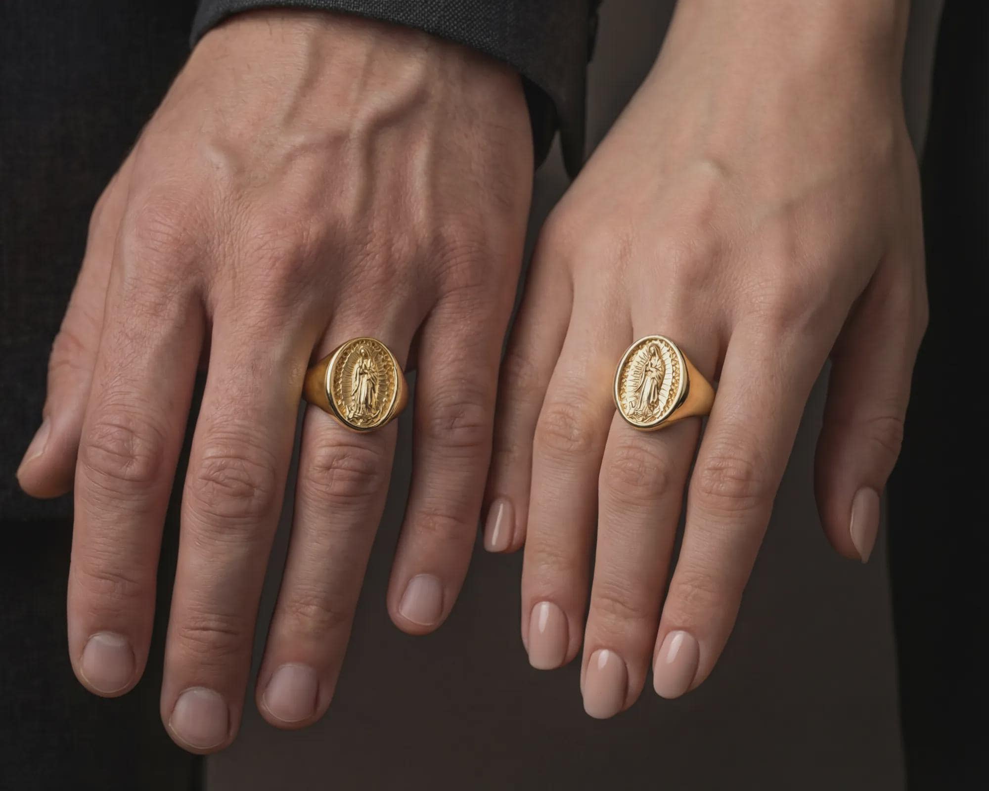 Gold plated Guadalupe signet ring worn on female hand as elegant faith jewelry