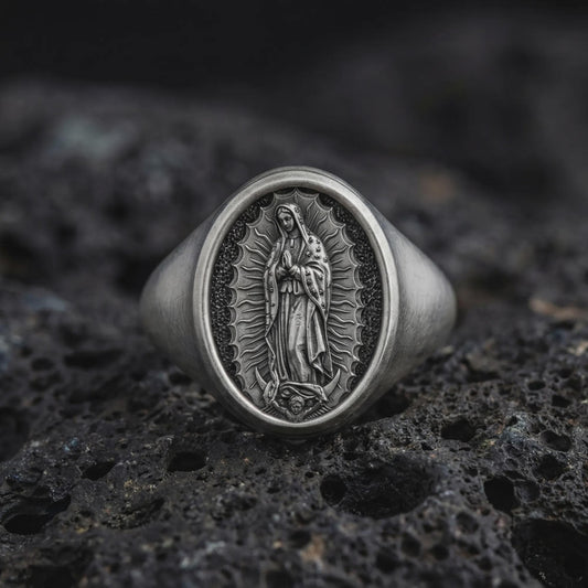 Oxidized Our Lady of Guadalupe signet ring in sterling silver photographed on volcanic rock background