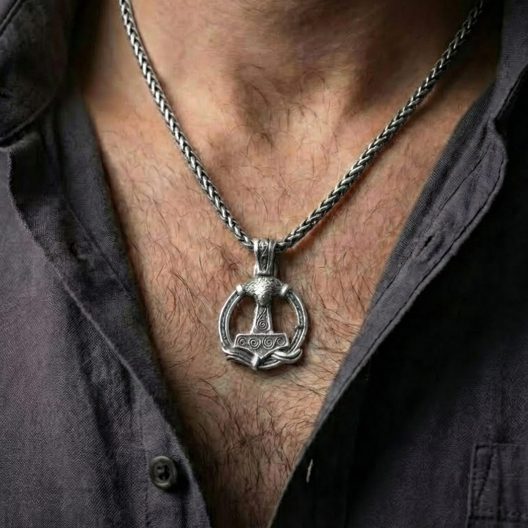 Oxidized Thor’s Hammer Mjölnir pendant necklace worn on male model as a Norse warrior talisman