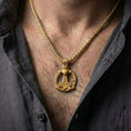 Load image into Gallery viewer, Gold plated Thor’s Hammer pendant necklace worn by man as bold Viking statement jewelry
