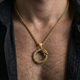 Load image into Gallery viewer, Gold plated ouroboros serpent pendant necklace worn by man as meaningful symbolic statement jewelry
