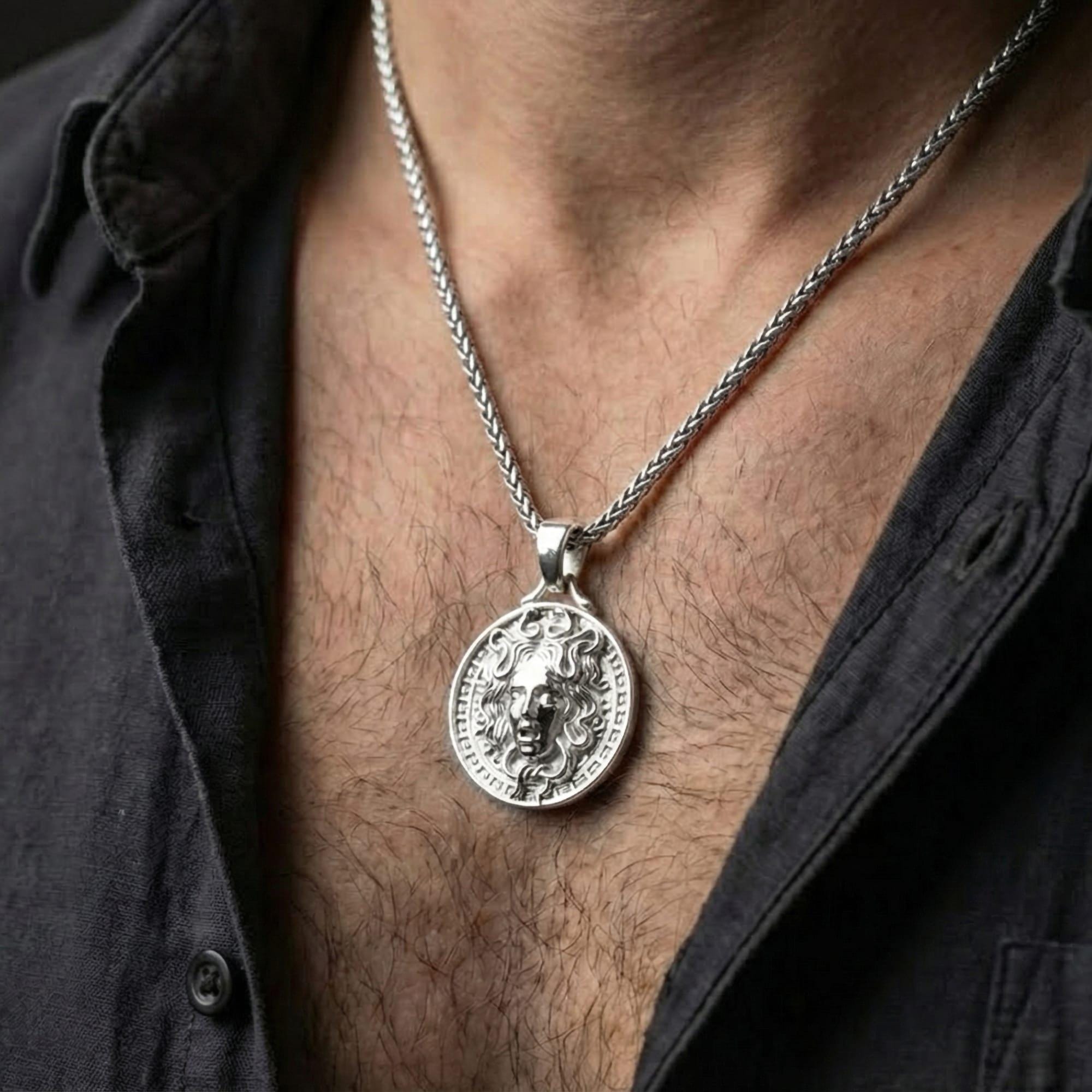 Polished silver Medusa amulet necklace worn on chest highlighting ancient Greek symbolism and strength