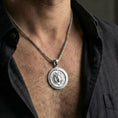 Load image into Gallery viewer, Polished silver Medusa Gorgon necklace worn on chest emphasizing ancient protection symbolism

