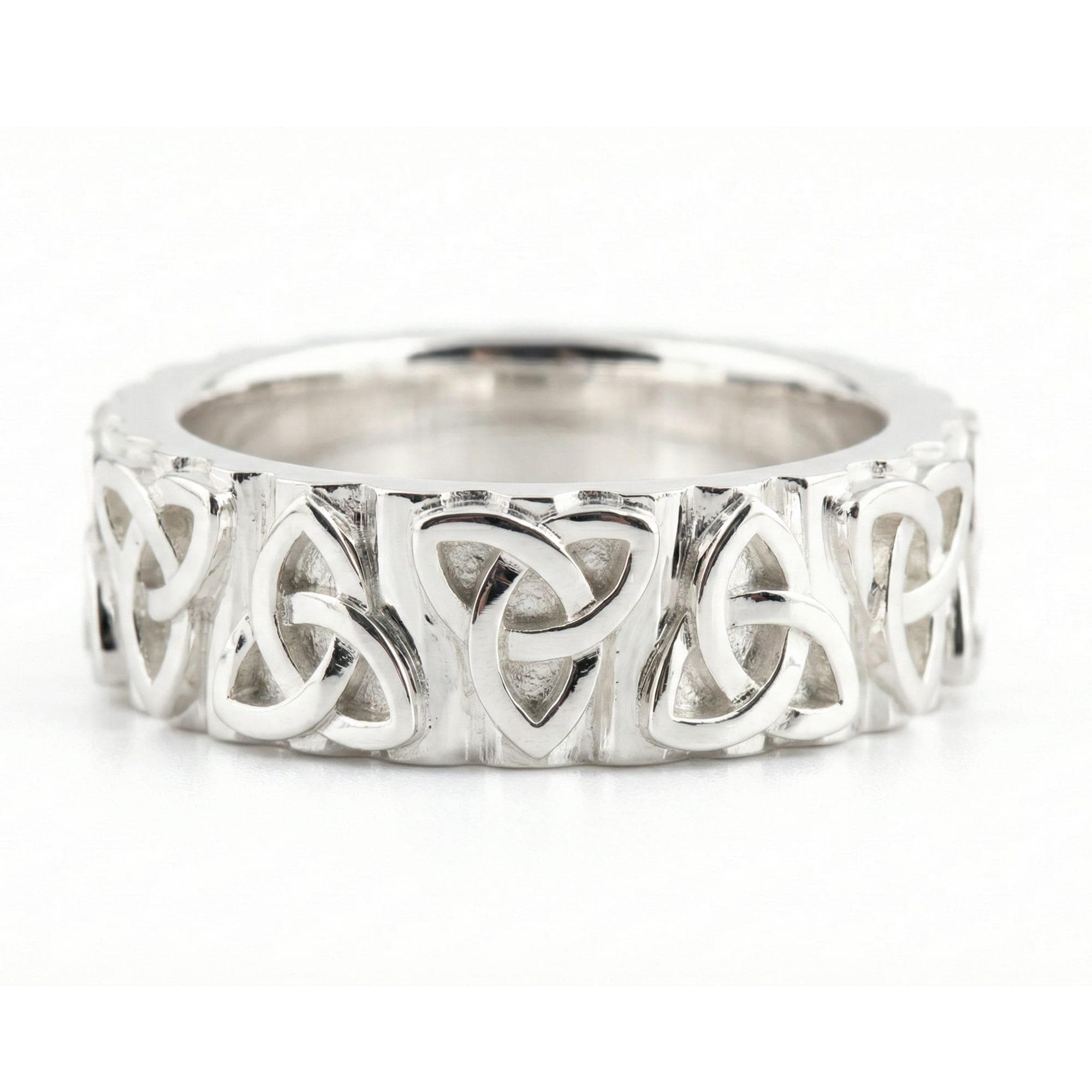 White Gold Celtic trinity knot band ring displayed on white surface as symbolic jewelry