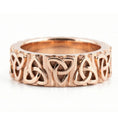 Load image into Gallery viewer, Rose Gold Celtic trinity knot band ring displayed on white surface as symbolic jewelry
