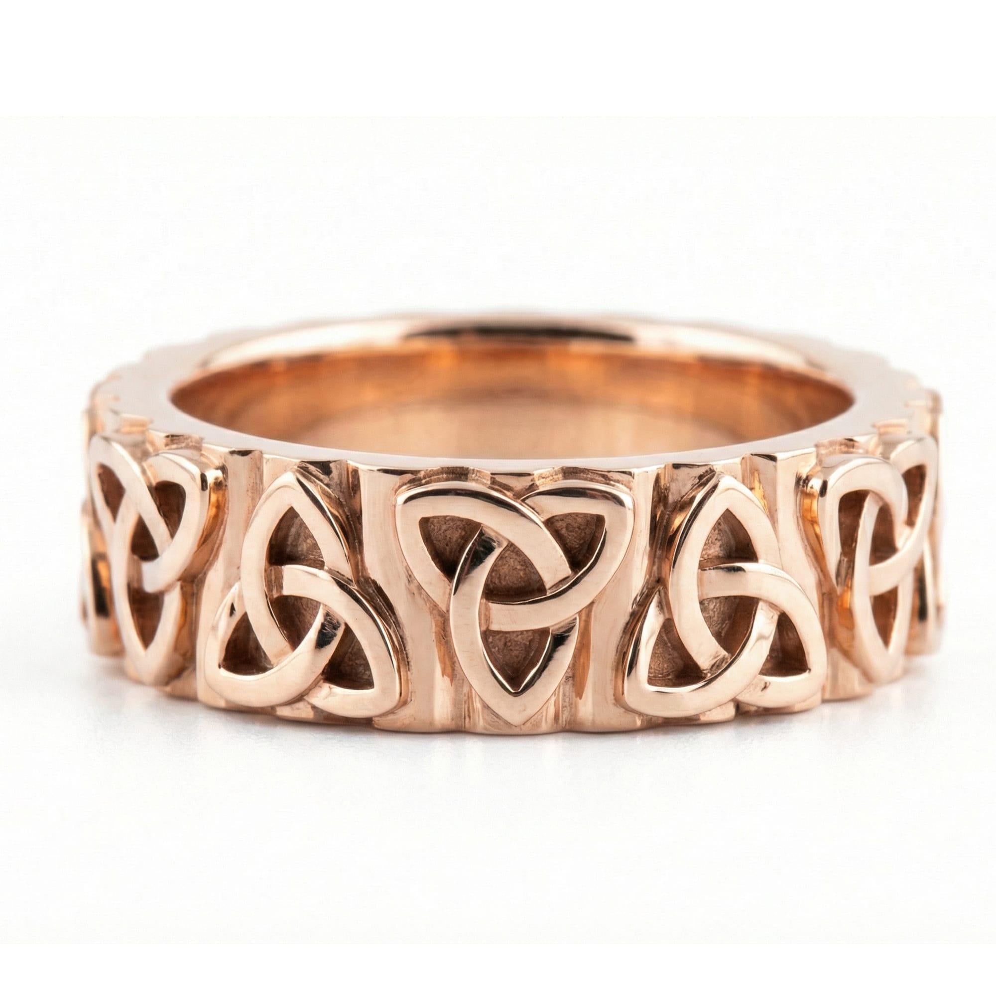 Rose Gold Celtic trinity knot band ring displayed on white surface as symbolic jewelry