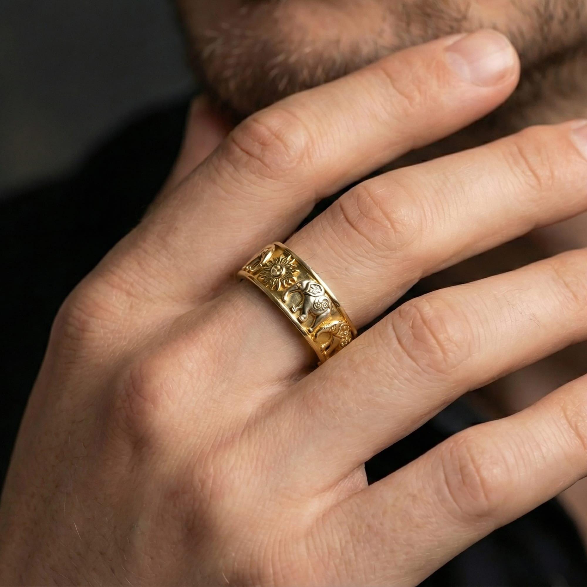 Gold plated faceted statement ring worn by man as a contemporary architectural band with premium shine and depth