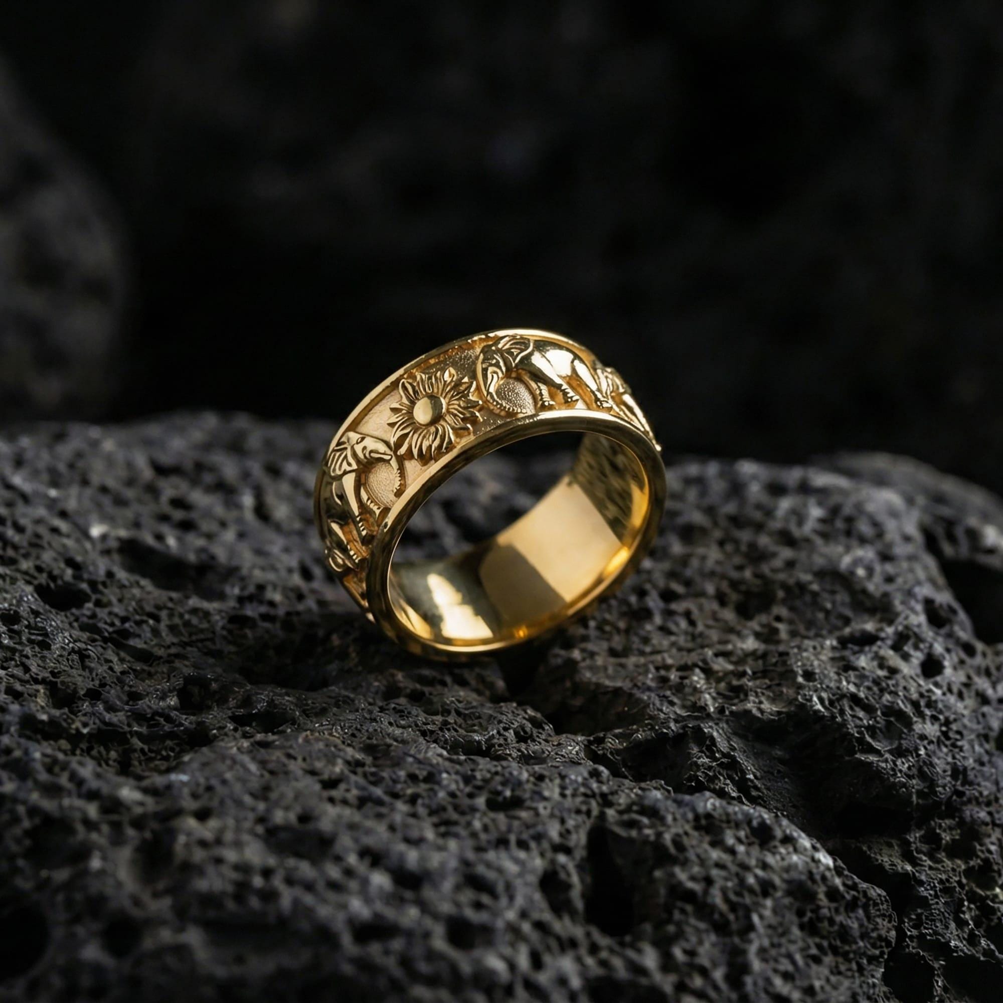 Gold plated geometric pyramid ring showcased on volcanic rock as a modern statement band with bold architectural depth